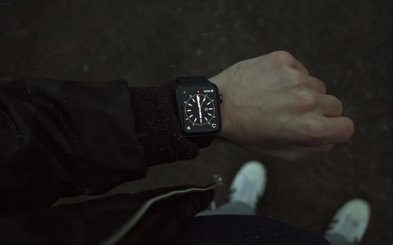 Apple Watch with a classic clock face on a wrist.